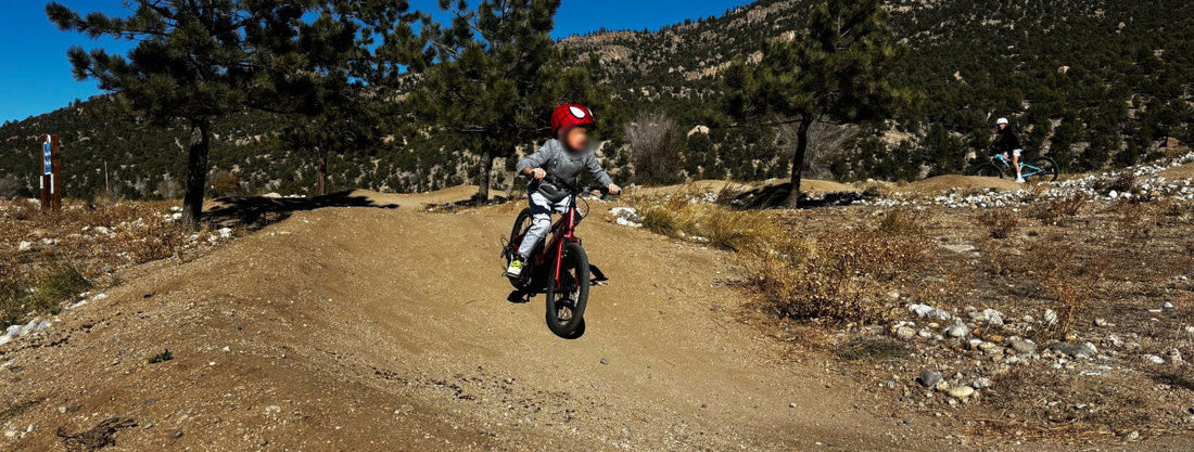 Active child jumping a bike on a dirt trail wearing Chakiboo™ RenewaKnee™ joggers