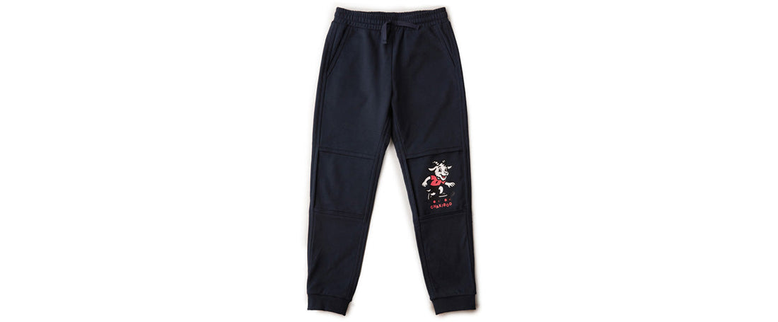 Navy RenewaKnee™ joggers with the inner knee layer revealed, showing the Chakiboo™ skateboarding goat character