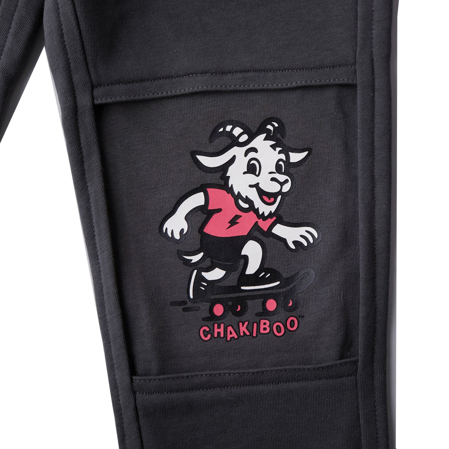 Close up of a revealed inner knee layer on slate gray Chakiboo™ RenewaKnee™ joggers featuring a skateboarder graphic